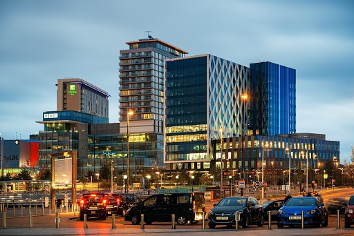 Manchester city skyline buildings in the evening.