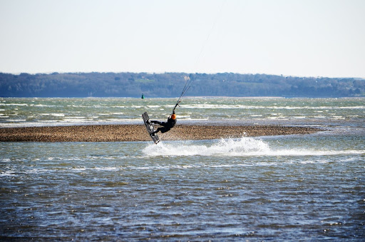 Person kitesurfing on the coast in Southampton, England.