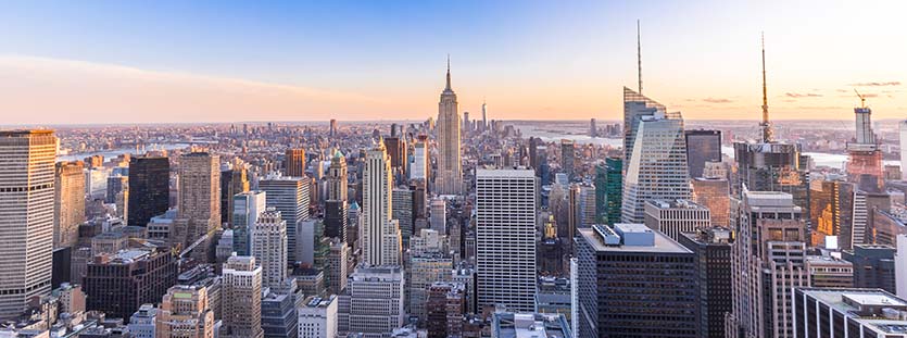 Panoramic photo of new york city skyline in manhattan downtown with skyscrapers at sunset usa