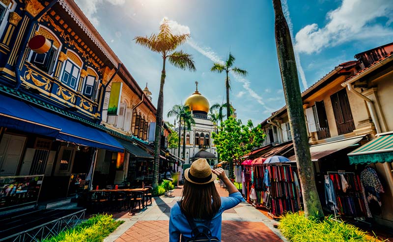 Young woman traveler traveling into The Masjid Sultan mosque located in Kampong Glam in Singapore city