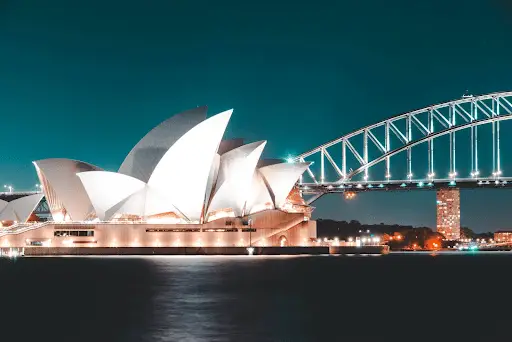 Sydney Opera House in the capital of Australia lit up in the evening.