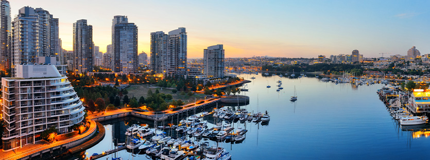 Vancouver harbor view with urban apartment buildings and bay boat in canada.