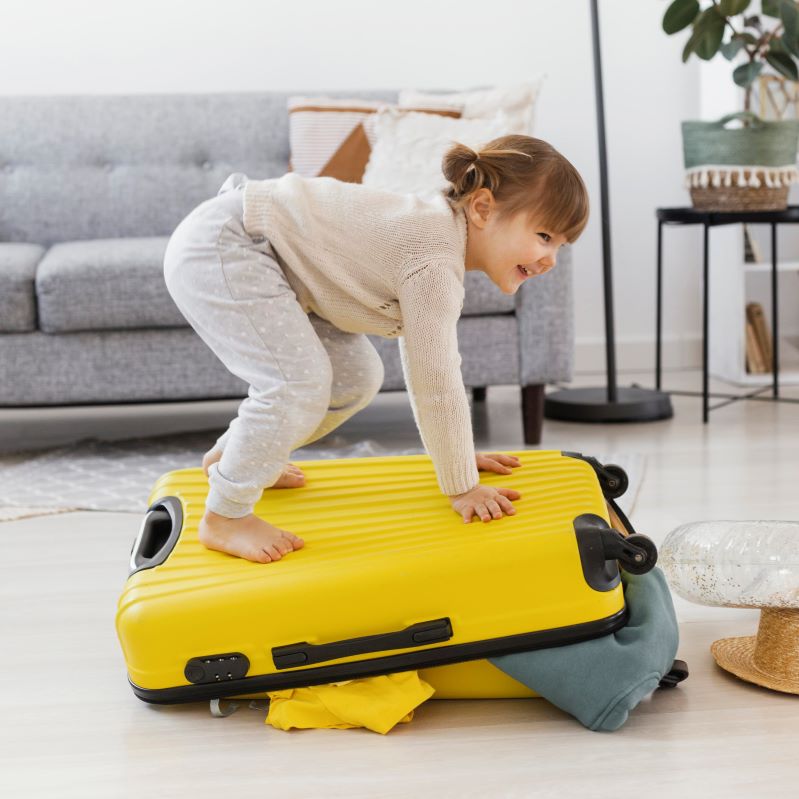 child-standing-luggage