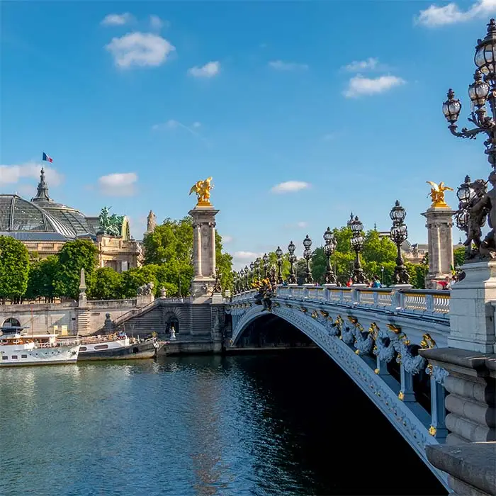 France. Summer Paris. Sunny day. River Seine and ships. Bridge of Alexander the Third. Grand Palais Glass Roof