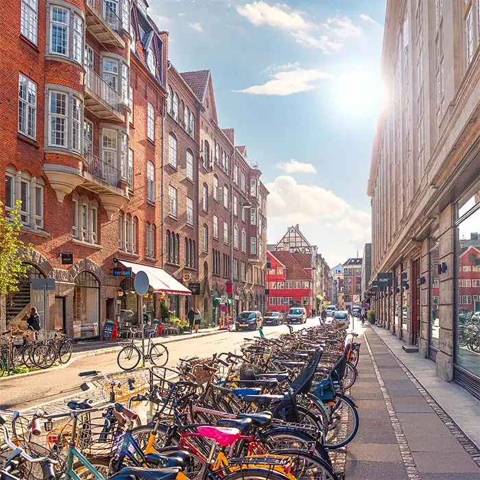 Many parked bikes on a narrow old Minter Street Møntergade in the Old Town of Copenhagen, Denmark