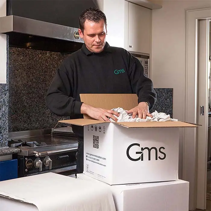 Packing fragile kitchenware into book carton