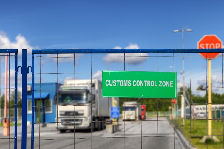 Trucks pass through the checkpoint of the customs logistics terminal.