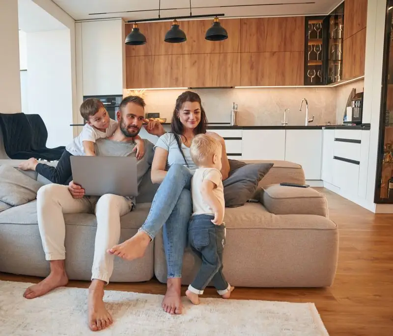 Front view Parents with two little boys kids are together in domestic room