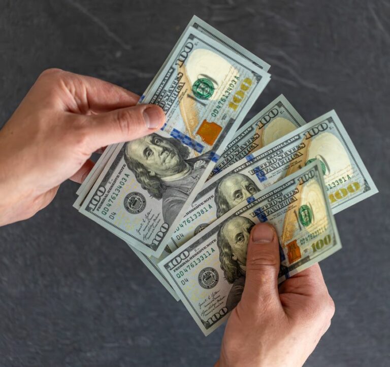 Hand holding money international currency exchange world money