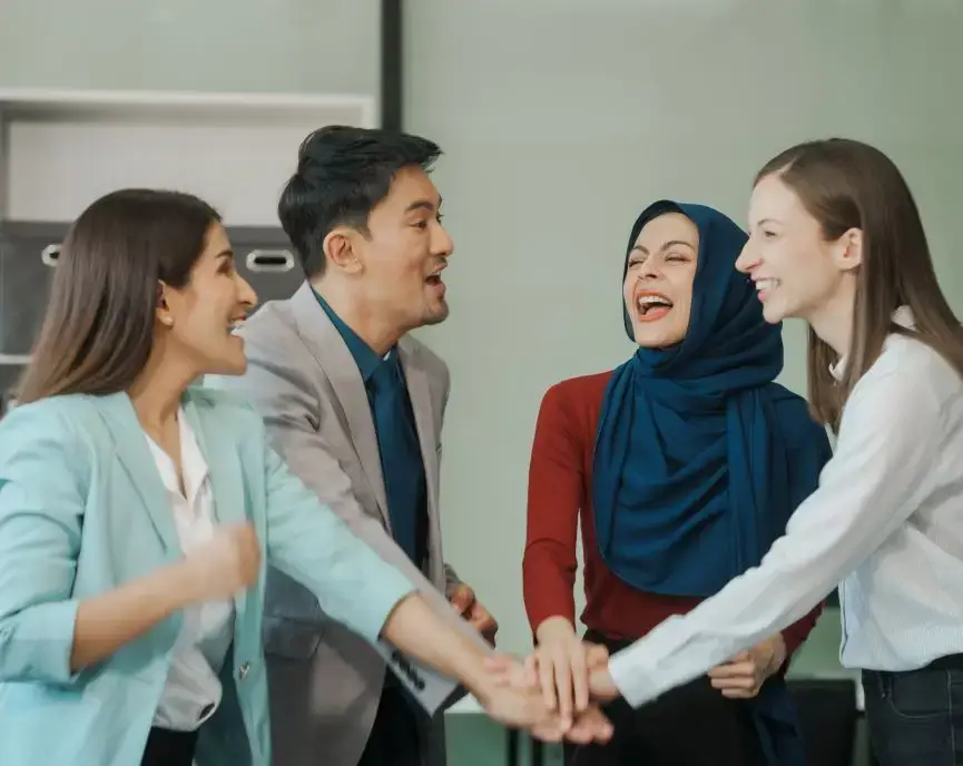 diverse team, including a middle-aged Asian businessman, Caucasian young businesswoman, Muslim hijab-wearing middle-aged businesswoman