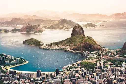 Aerial view of the city and coastline of Rio de Janeiro, Brazil, looking out onto the sea and islands