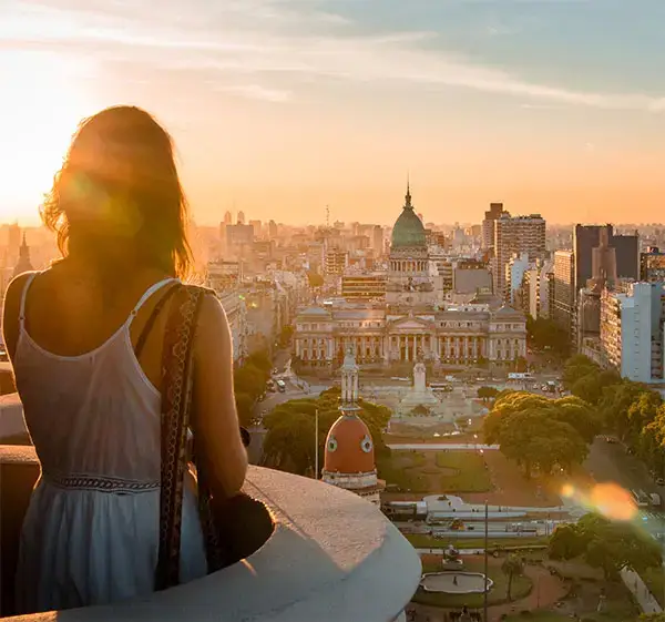 Rear View Of Woman Standing At Balcony Against Cityscape During Sunset in Buenos Aires, Argentina