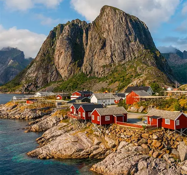 View of the red cottages by the coastline in hamnøy, lofoten islands, norway