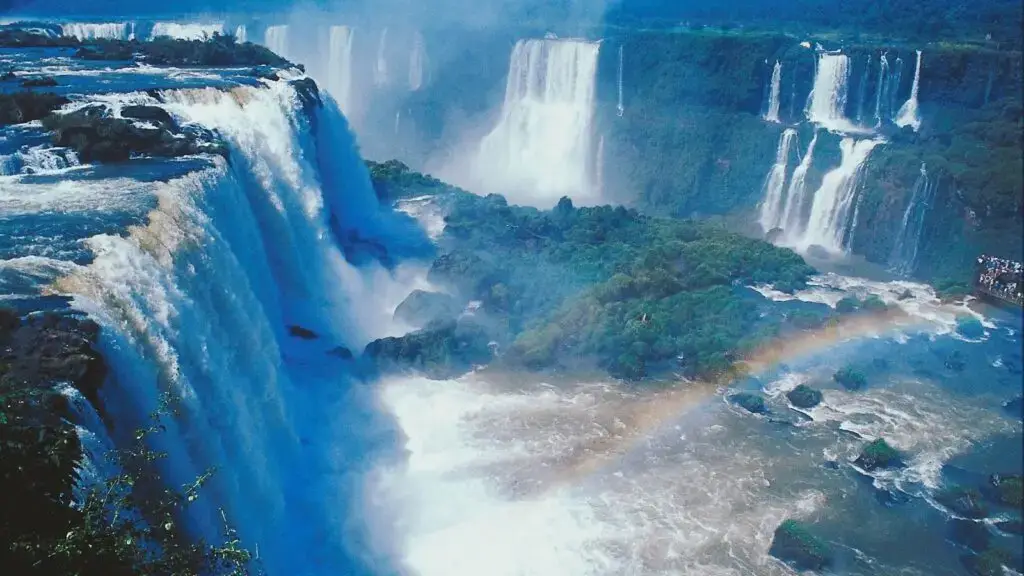 aerial view of the Iguacu Falls in Brazil with a rainbow in the foreground