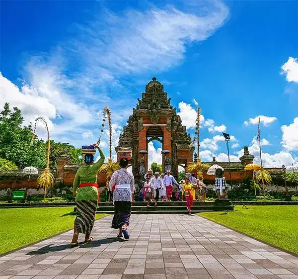 balinese people in traditional clothes during religious ceremony at pura taman ayun temple, bali in indonesia
