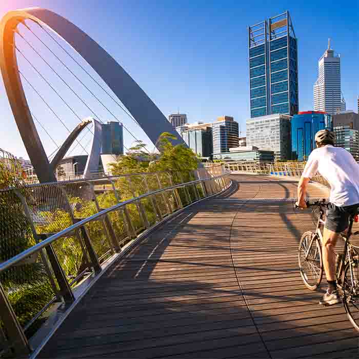 A man cycling on an elizabeth bridge in Perth