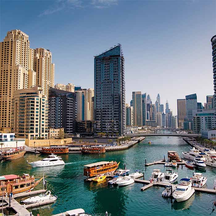 Dubai marina with boats and buildings, united arab emirates