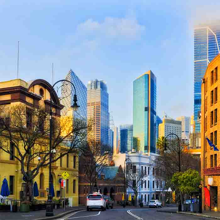 Old and new towers in Sydney city CBD from The Rocks at sunrise in Australia