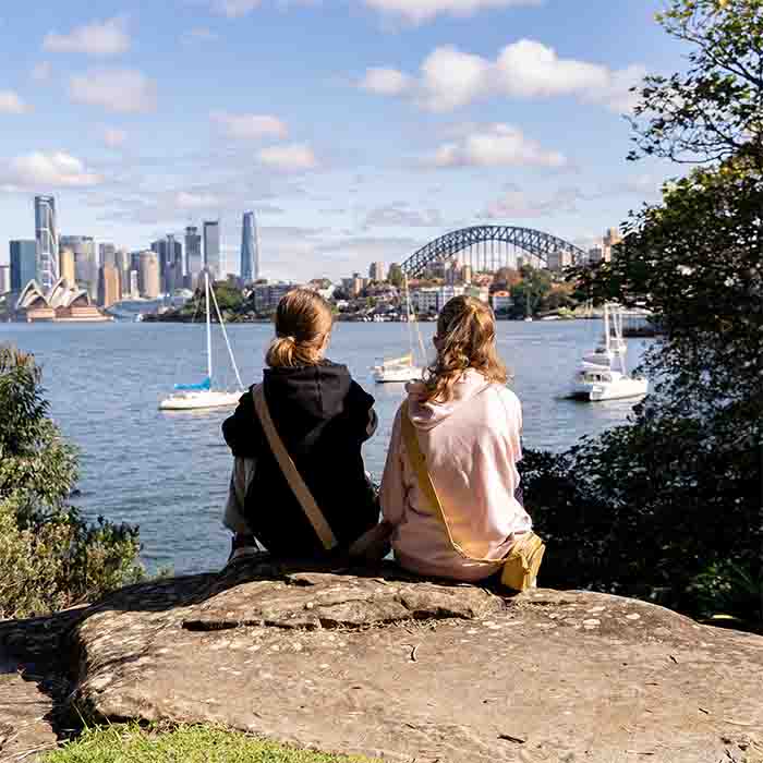 Two young girls are enjoying a beautiful Sydney view from Cremorne Point