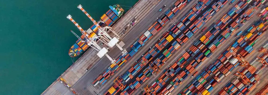 Smart crane loanding cargo container to container ship in the international terminal depot sea yard port concept freight shipping by ship