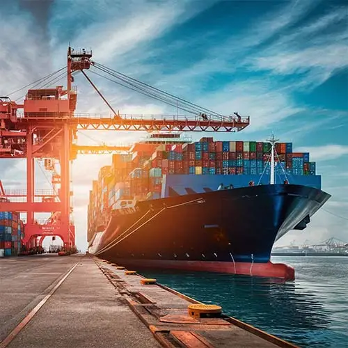 A large container ship is docked in the water