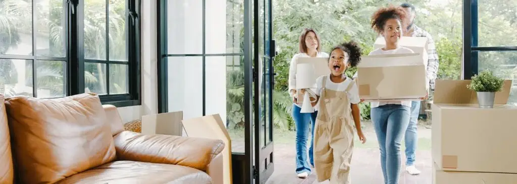 Happy family moving into their new home in summer