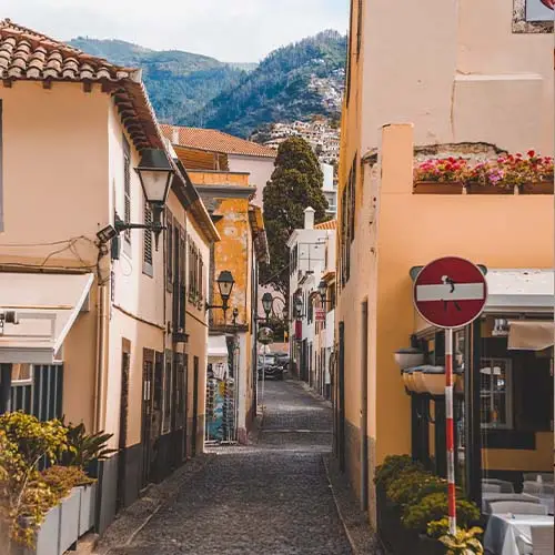 Vertical shot of a pathway in the middle of buildings in funchal, madeira, portugal